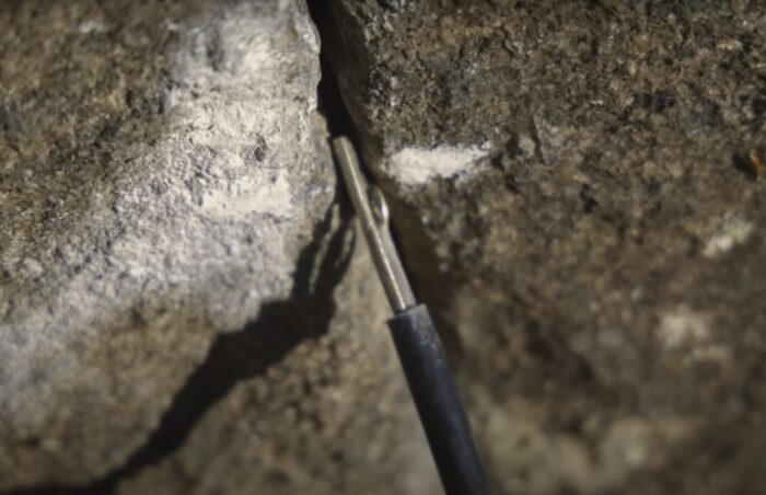 placing a ballnut in a tiny crack in a cliff
